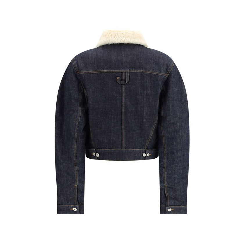 Blue Cotton SweatshirtThe De-Nîmes Ovalo Denim Bomber by Jacquemus reimagines the classic aviator silhouette with a contemporary and artisanal touch. Crafted from rinsed raw indigo denim, it features contrasting stitching and a pointed faux-shearling coll