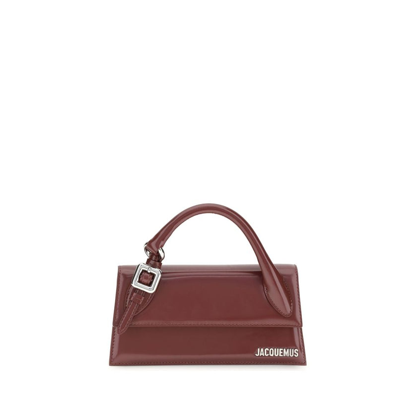 Bordeaux Calf Leather Bos Taurus HandbagThe Chiquito Handbag with Buckle from Jacquemus is a long, structured design made of smooth leather. Featuring a reinforced handle with metal buckle, it has a flap with magnetic closure and an adjustable, removable