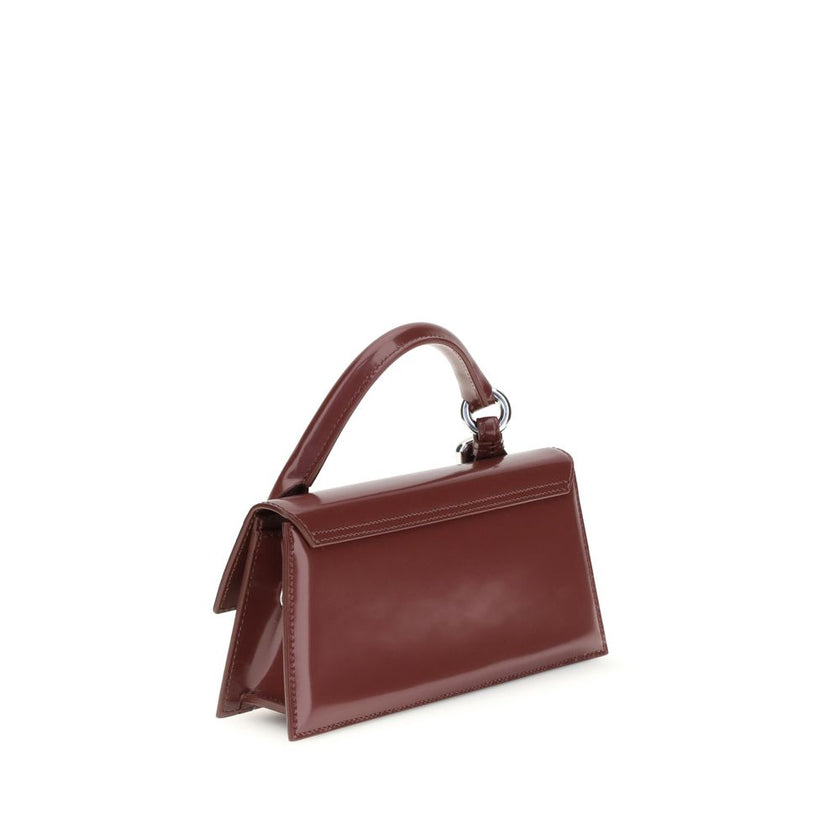 Bordeaux Calf Leather Bos Taurus HandbagThe Chiquito Handbag with Buckle from Jacquemus is a long, structured design made of smooth leather. Featuring a reinforced handle with metal buckle, it has a flap with magnetic closure and an adjustable, removable