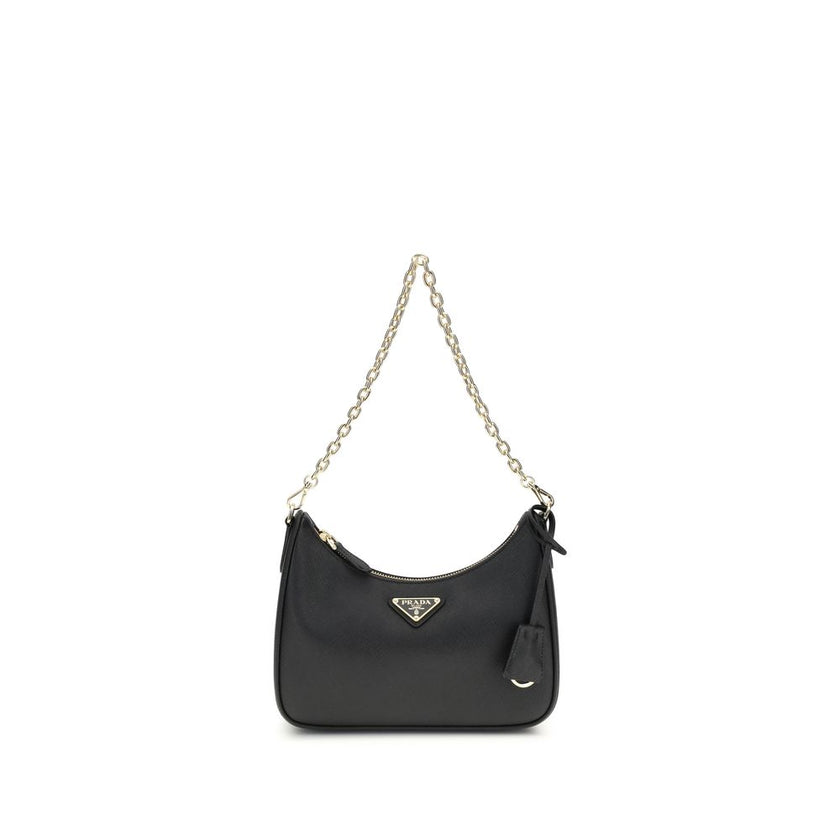 Black Recycled Polyamide Shoulder BagThe 2005 Re-Edition Shoulder Bag by Prada is made of Saffiano leather, with an elegant logoed triangle on the front and a removable leather accessory with key ring. Equipped with a metal chain handle and adjustable ton
