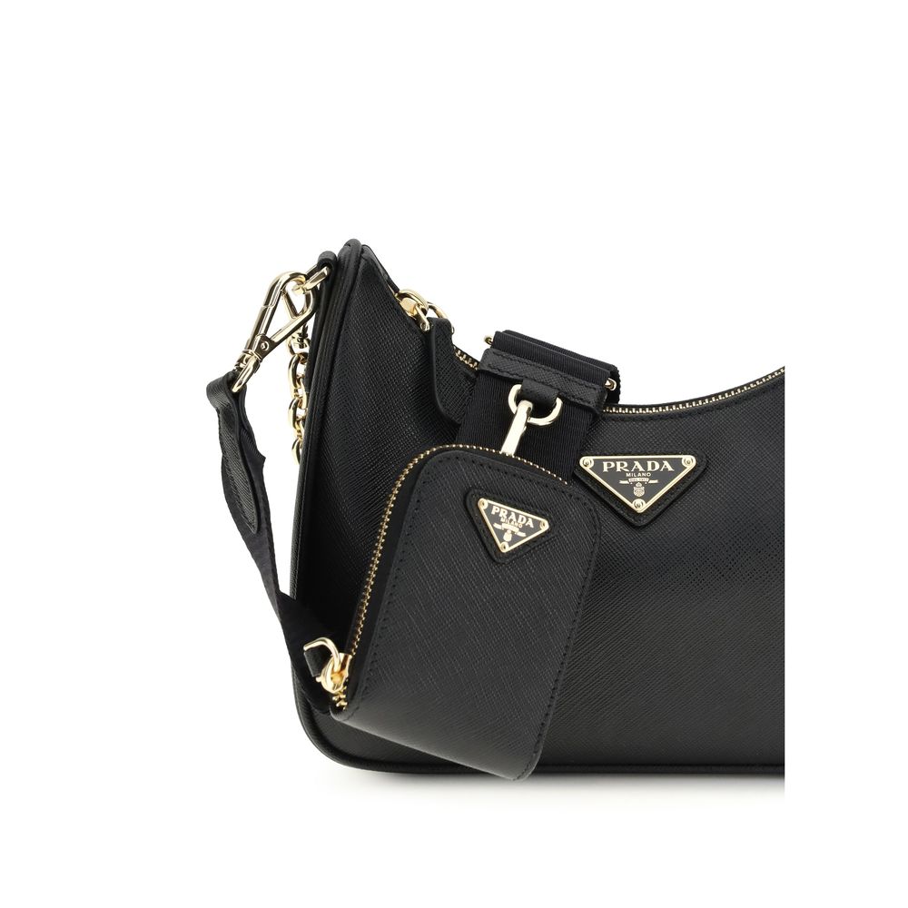 Black Recycled Polyamide Shoulder BagThe 2005 Re-Edition Shoulder Bag by Prada is made of Saffiano leather, with an elegant logoed triangle on the front and a removable leather accessory with key ring. Equipped with a metal chain handle and adjustable ton
