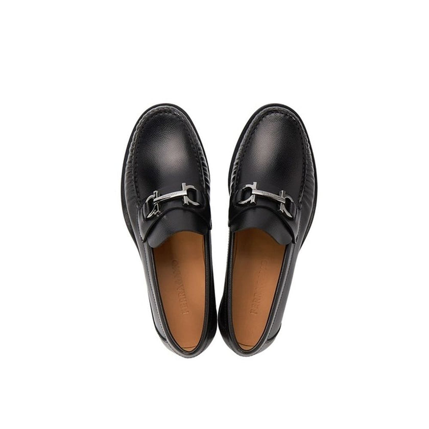 Black Calfskin Slip-On LoafersDescription: – Composition: 100% calf leather – Inner: Leather – Insole: Leather – Sole: Leather – Round toe – Grained-effect – Slip-on design – Glossy trim – Extrawide insole – Silver-tone ‘Gancini’ hardware – Made in Italy