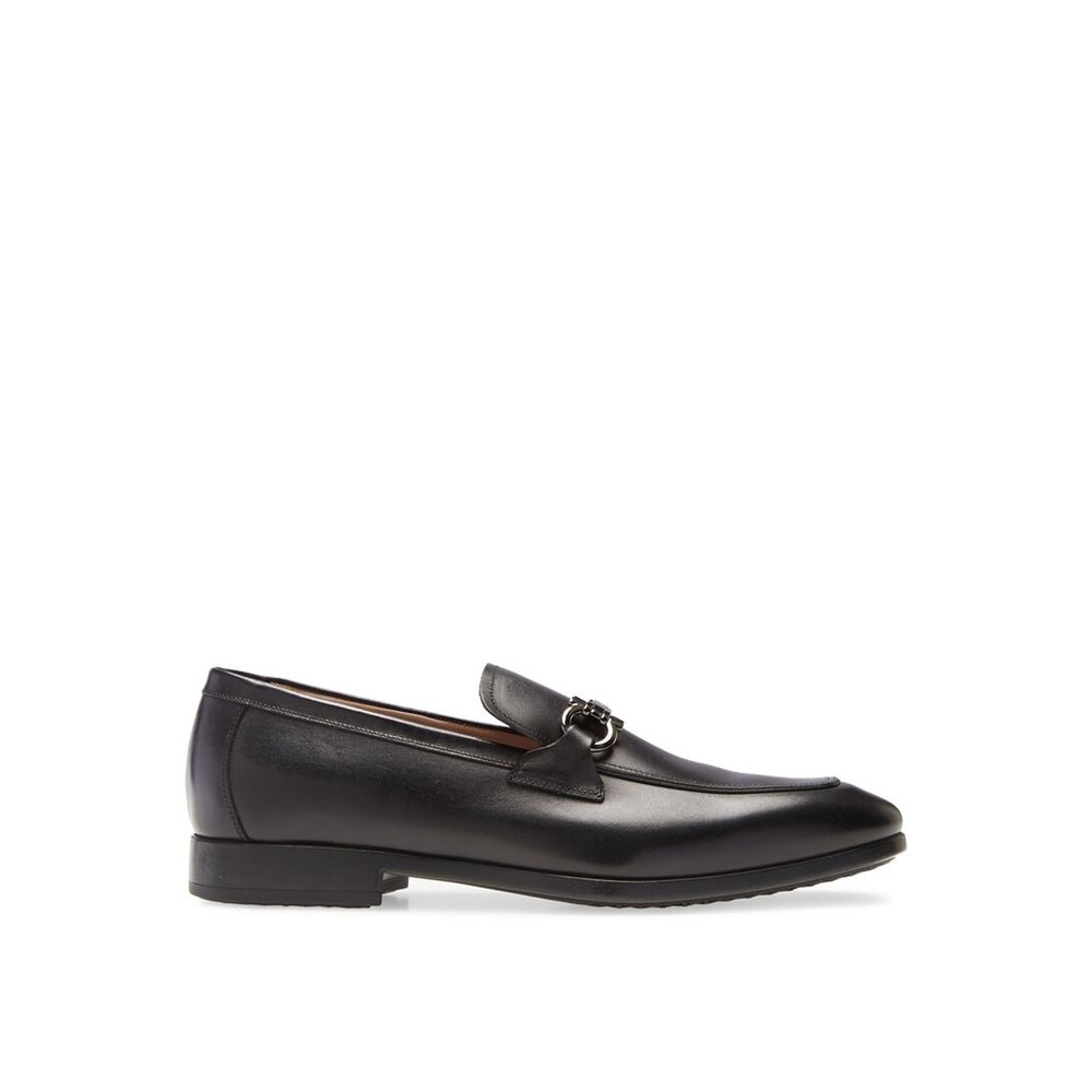 Black Calfskin Slip-On LoafersDescription: – Composition: 100% calf leather – Inner: Leather – Insole: Leather – Sole: Rubber – Branded insole – Almond toe – Top logo hardware – Low stacked heel – Made in Italy – Gender: MEN – Size & Fit: This piece fits
