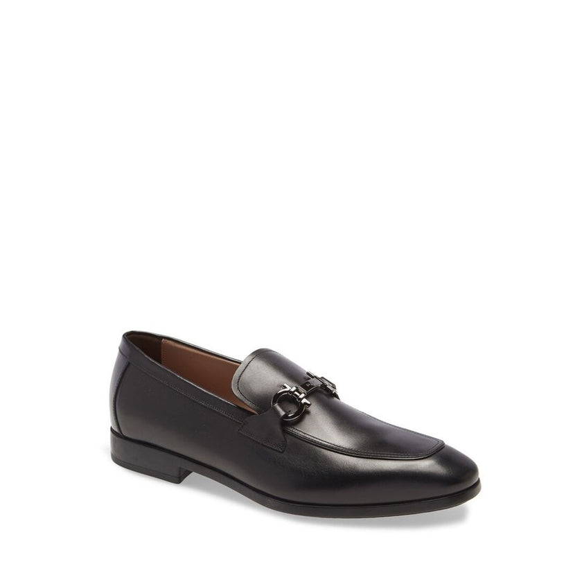 Black Calfskin Slip-On LoafersDescription: – Composition: 100% calf leather – Inner: Leather – Insole: Leather – Sole: Rubber – Branded insole – Almond toe – Top logo hardware – Low stacked heel – Made in Italy – Gender: MEN – Size & Fit: This piece fits
