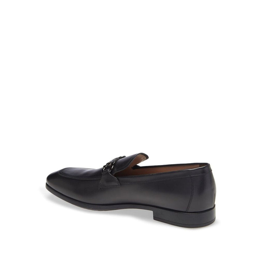Black Calfskin Slip-On LoafersDescription: – Composition: 100% calf leather – Inner: Leather – Insole: Leather – Sole: Rubber – Branded insole – Almond toe – Top logo hardware – Low stacked heel – Made in Italy – Gender: MEN – Size & Fit: This piece fits