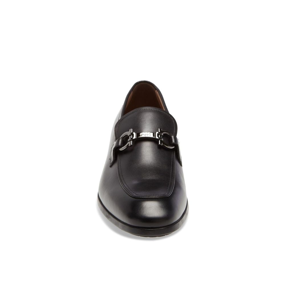 Black Calfskin Slip-On LoafersDescription: – Composition: 100% calf leather – Inner: Leather – Insole: Leather – Sole: Rubber – Branded insole – Almond toe – Top logo hardware – Low stacked heel – Made in Italy – Gender: MEN – Size & Fit: This piece fits