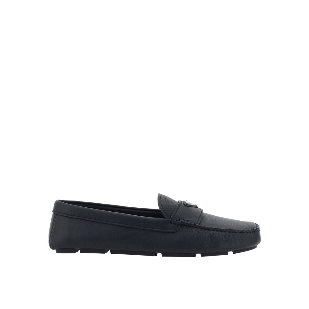 Black Calfskin Slip-On LoafersDescription: – Composition: 100% calf leather – Inner: Leather – Insole: Leather – Sole: Rubber – Round toe – Textured leather – Branded insole – Non-slip knurled sole – Iconic triangular signature brand plaque – Made in Ital