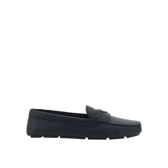 Black Calfskin Slip-On LoafersDescription: – Composition: 100% calf leather – Inner: Leather – Insole: Leather – Sole: Rubber – Round toe – Textured leather – Branded insole – Non-slip knurled sole – Iconic triangular signature brand plaque – Made in Ital