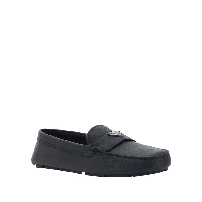 Black Calfskin Slip-On LoafersDescription: – Composition: 100% calf leather – Inner: Leather – Insole: Leather – Sole: Rubber – Round toe – Textured leather – Branded insole – Non-slip knurled sole – Iconic triangular signature brand plaque – Made in Ital