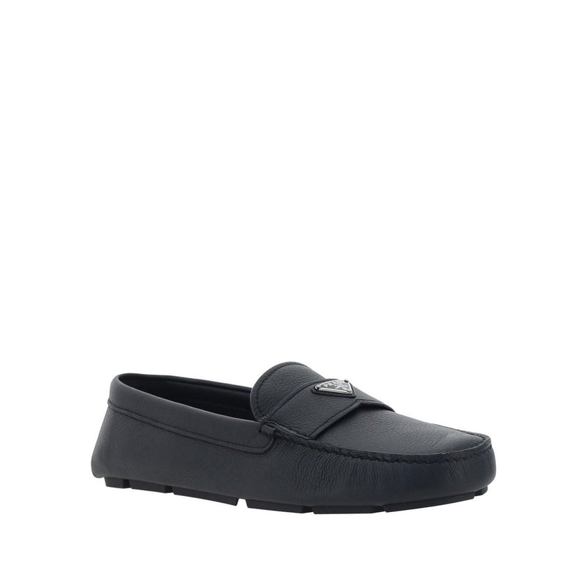 Black Calfskin Slip-On LoafersDescription: – Composition: 100% calf leather – Inner: Leather – Insole: Leather – Sole: Rubber – Round toe – Textured leather – Branded insole – Non-slip knurled sole – Iconic triangular signature brand plaque – Made in Ital