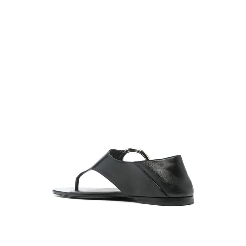 Black Calfskin Strap-On SandalsDescription: – Composition: 100% calf leather – Inner: Leather – Insole: Leather – Sole: Leather – Round toe – Branded insole – Slip-on design – Smooth grain leather – Thong strap – Silver-tone ring hardware detailing – Made