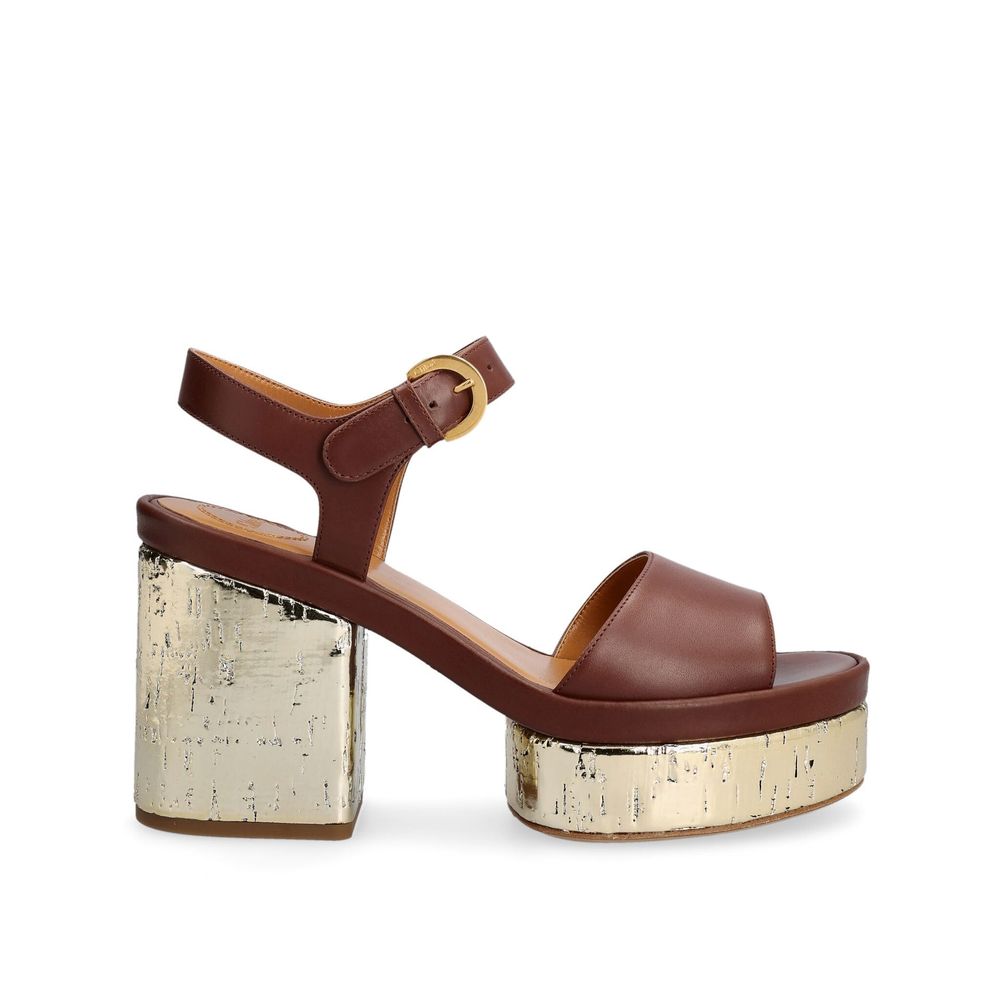 Brown Calfskin Platform SandalsDescription: – Composition: 100% calf leather – Inner: Leather – Insole: Leather – Sole: Leather – Heel: 10.0 cm / 25.4 in – Platform: 4.0 cm / 10.16 in – round toe – Logo ankle buckle closure – patent side detail – Gender: