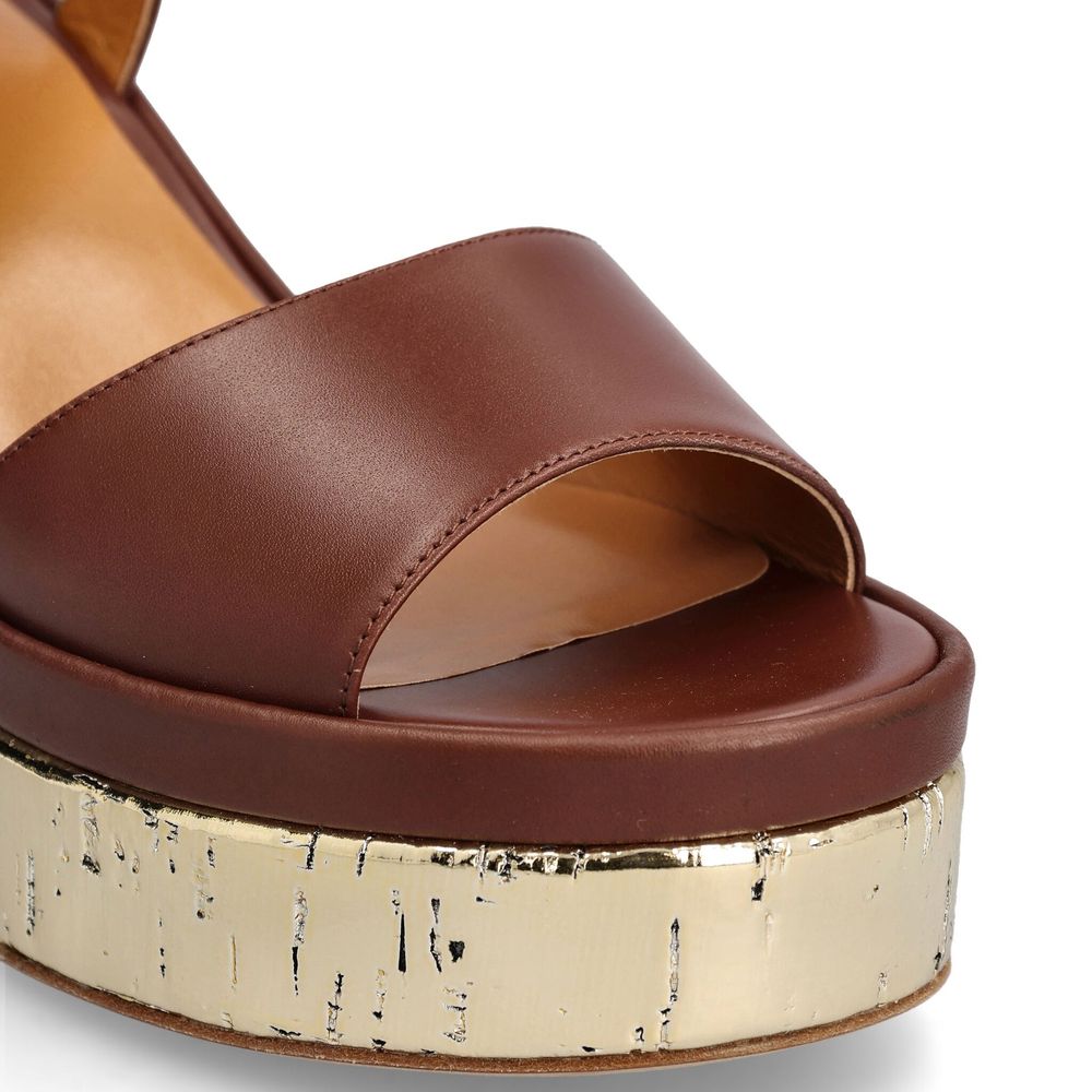 Brown Calfskin Platform SandalsDescription: – Composition: 100% calf leather – Inner: Leather – Insole: Leather – Sole: Leather – Heel: 10.0 cm / 25.4 in – Platform: 4.0 cm / 10.16 in – round toe – Logo ankle buckle closure – patent side detail – Gender: