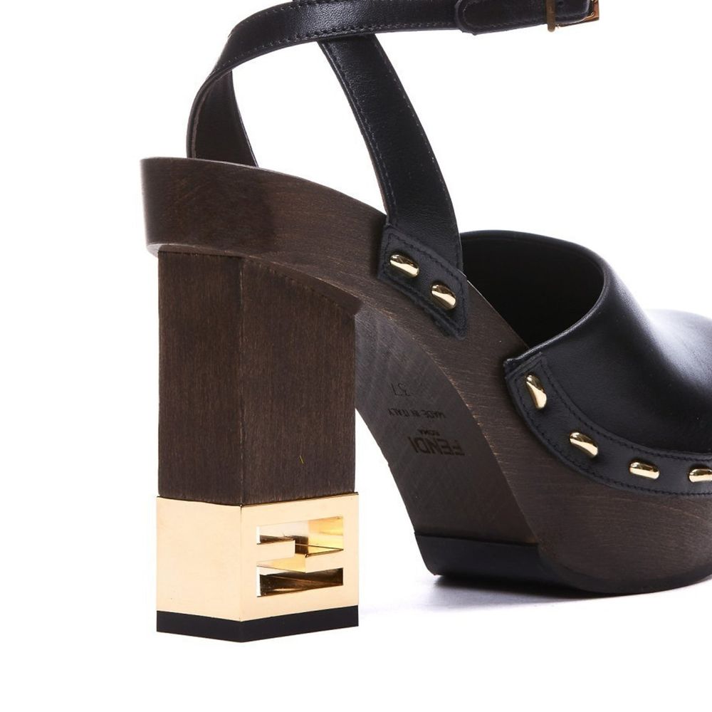 Black Calfskin ClogsDescription: – Composition: 100% calf leather – Inner: Leather – Insole: Leather – Sole: Rubber – Heel: 9.5 cm / 24.13 in – Round toe – Made in Italy – Logo ankle buckle closure – Gold-tone decorative heel – Gender: WOMEN –Black Calfsk