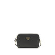 Black Calf Leather Bos Taurus Shoulder BagMini Shoulder Bag by Prada is a compact and essential accessory perfect for everyday use. Featuring a zippered top closure and an adjustable, removable shoulder strap, it combines practicality and style. The inter