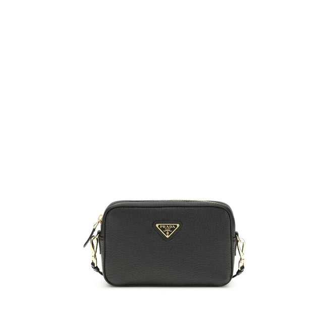 Black Calf Leather Bos Taurus Shoulder BagMini Shoulder Bag by Prada is a compact and essential accessory perfect for everyday use. Featuring a zippered top closure and an adjustable, removable shoulder strap, it combines practicality and style. The inter