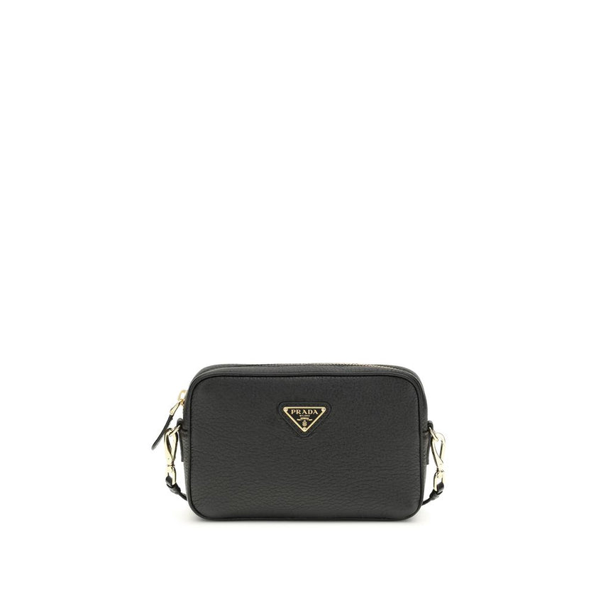 Black Calf Leather Bos Taurus Shoulder BagMini Shoulder Bag by Prada is a compact and essential accessory perfect for everyday use. Featuring a zippered top closure and an adjustable, removable shoulder strap, it combines practicality and style. The inter