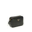 Black Calf Leather Bos Taurus Shoulder BagMini Shoulder Bag by Prada is a compact and essential accessory perfect for everyday use. Featuring a zippered top closure and an adjustable, removable shoulder strap, it combines practicality and style. The inter