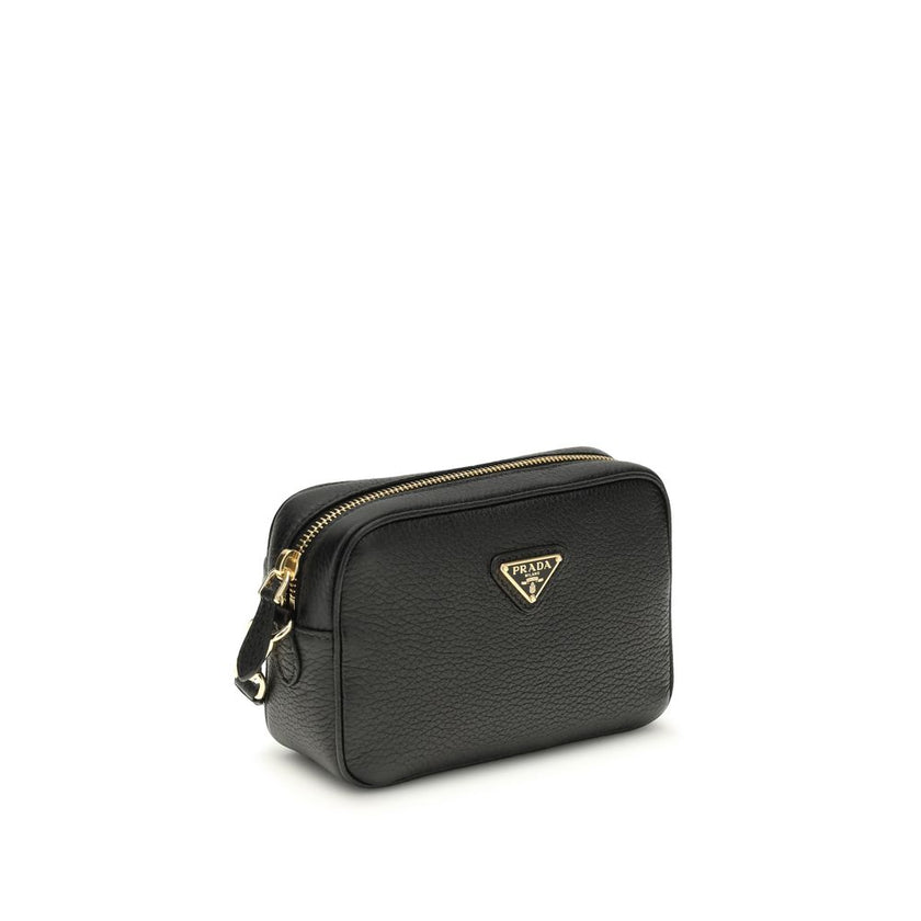 Black Calf Leather Bos Taurus Shoulder BagMini Shoulder Bag by Prada is a compact and essential accessory perfect for everyday use. Featuring a zippered top closure and an adjustable, removable shoulder strap, it combines practicality and style. The inter