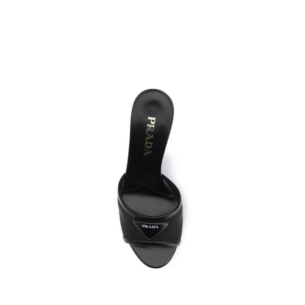 Black Calf Leather Bos Taurus Stiletto Heel SandalsThe mesh slipper Sandals by Prada combine lightness and contemporary style in a sophisticated design. The mesh strap is accented by the iconic triangular leather logo plaque, while the stiletto heel lends