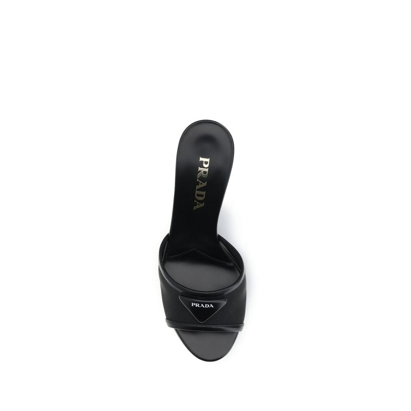 Black Calf Leather Bos Taurus Stiletto Heel SandalsThe mesh slipper Sandals by Prada combine lightness and contemporary style in a sophisticated design. The mesh strap is accented by the iconic triangular leather logo plaque, while the stiletto heel lends