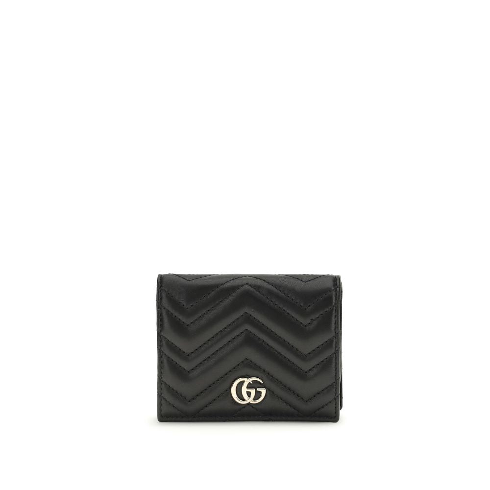 Black Lamb Ovis Aries Aries WalletThe GG Marmont Wallet by Gucci is an elegant and functional accessory made of matelassé nappa leather with a pinkish beige chevron pattern. The design is embellished with light gold-tone hardware and the famous double G o
