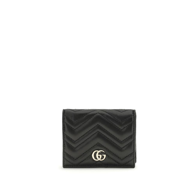 Black Lamb Ovis Aries Aries WalletThe GG Marmont Wallet by Gucci is an elegant and functional accessory made of matelassé nappa leather with a pinkish beige chevron pattern. The design is embellished with light gold-tone hardware and the famous double G o