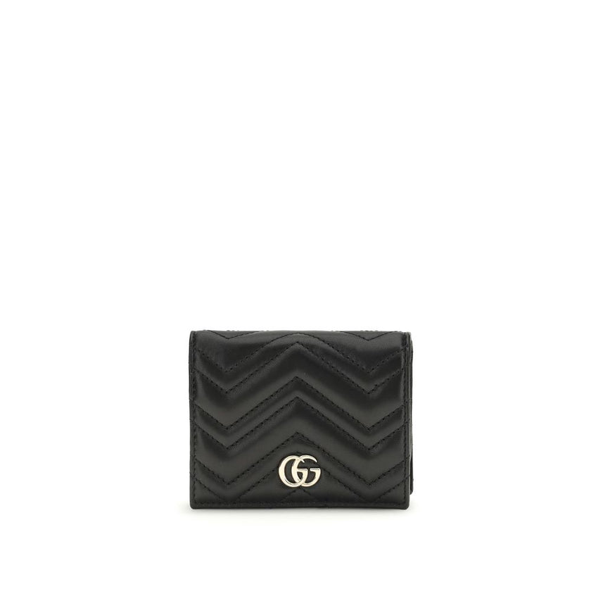 Black Lamb Ovis Aries Aries WalletThe GG Marmont Wallet by Gucci is an elegant and functional accessory made of matelassé nappa leather with a pinkish beige chevron pattern. The design is embellished with light gold-tone hardware and the famous double G o
