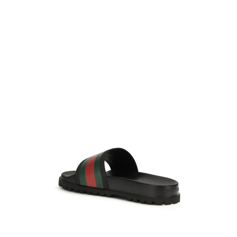 Black Rubber SlippersThe rubber Slippers by Gucci are part of the Gucci Lido line and reinterpret one of the Maison’s most iconic symbols in a pop twist: the green and red Web ribbon. Made of black rubber and featuring a slip-on design, they combine comfo