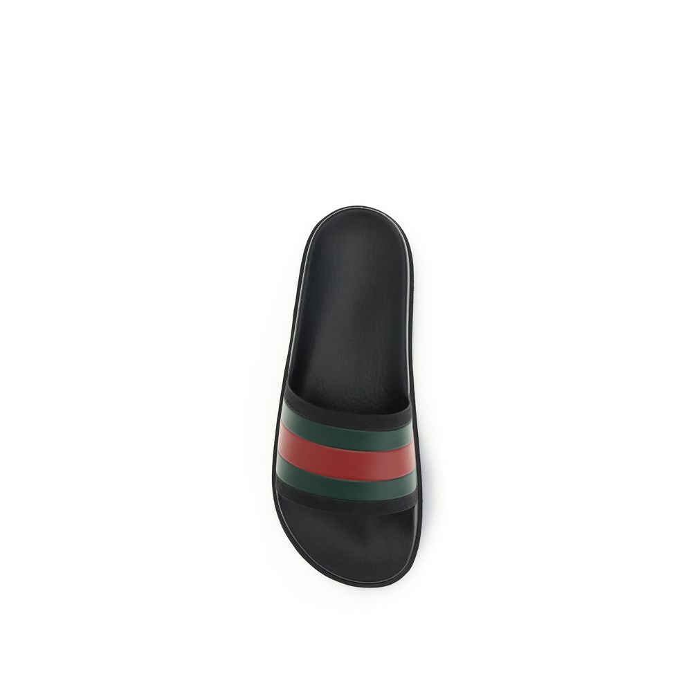 Black Rubber SlippersThe rubber Slippers by Gucci are part of the Gucci Lido line and reinterpret one of the Maison’s most iconic symbols in a pop twist: the green and red Web ribbon. Made of black rubber and featuring a slip-on design, they combine comfo