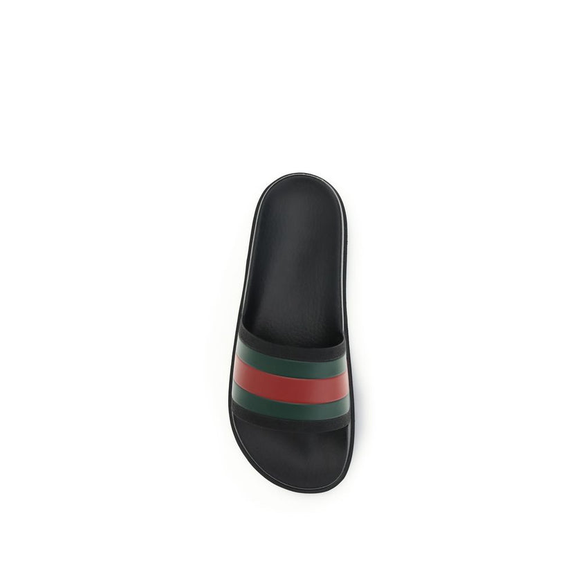 Black Rubber SlippersThe rubber Slippers by Gucci are part of the Gucci Lido line and reinterpret one of the Maison’s most iconic symbols in a pop twist: the green and red Web ribbon. Made of black rubber and featuring a slip-on design, they combine comfo
