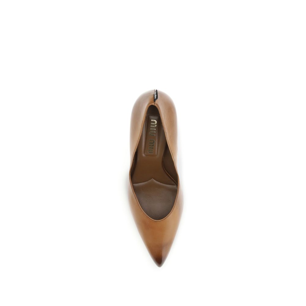Beige Calf Leather Bos Taurus High Heel PumpsThe Miu Miu leather heels are crafted from vintage-effect leather, giving them a timeless and sophisticated charm. The design is enhanced by a branded label on the heel, an iconic detail that highlights the mai