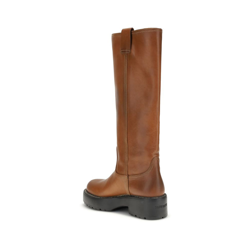 Brown Calf Leather Bos Taurus BootsThe Leather Boots by Miu Miu are crafted from smooth, premium leather and stand out for their sleek yet refined design. They feature a logo tab on the front and a double pull tab for easier wear, adding a signature touch