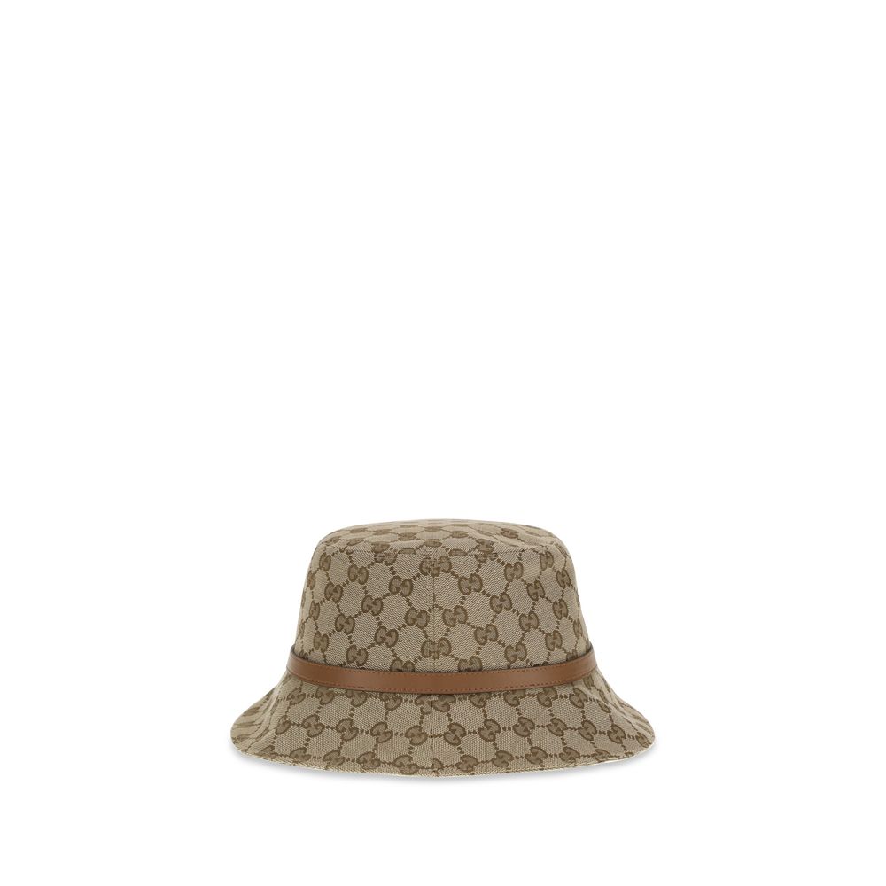 Beige Polyester Bucket HatThe GG Supreme fabric Bucket Hat by Gucci combines style and functionality in a distinctive accessory. Made of GG fabric, it is enhanced by a leather strap with GG detail and completed with an inner lining, for a model that combi
