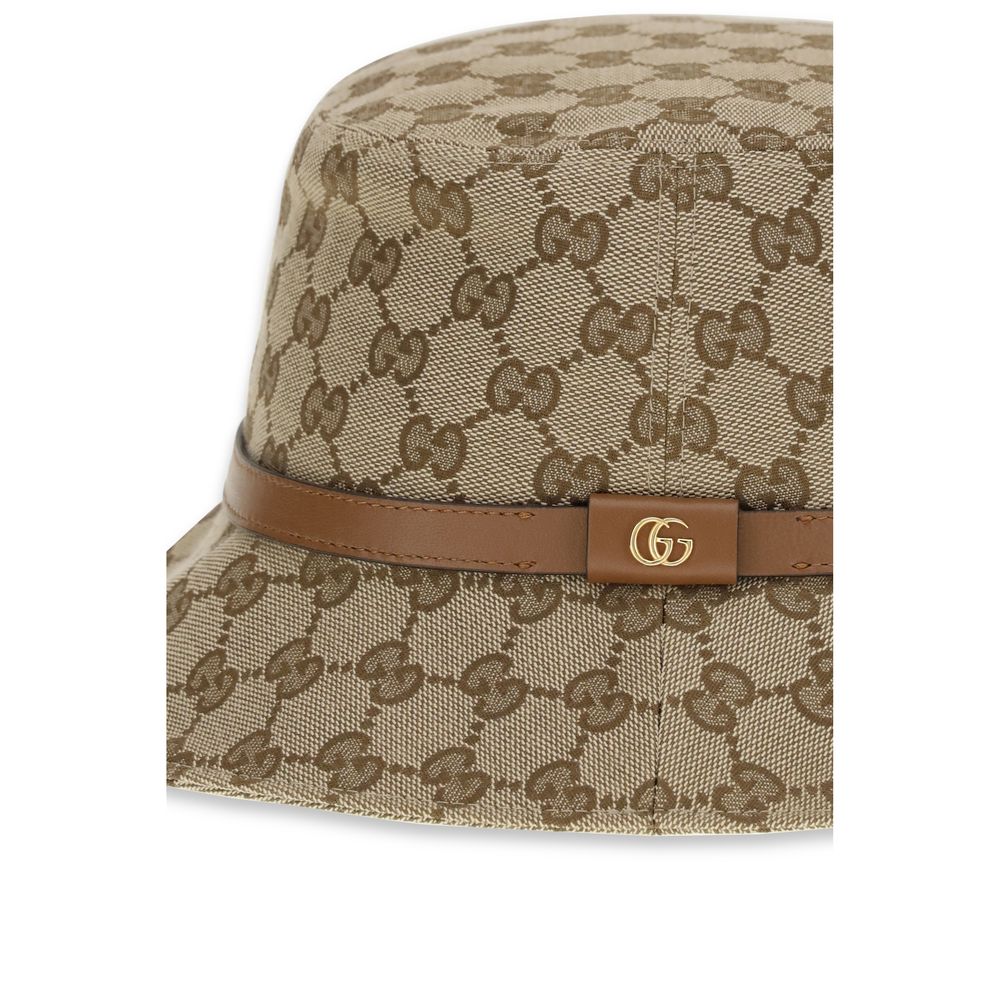Beige Polyester Bucket HatThe GG Supreme fabric Bucket Hat by Gucci combines style and functionality in a distinctive accessory. Made of GG fabric, it is enhanced by a leather strap with GG detail and completed with an inner lining, for a model that combi