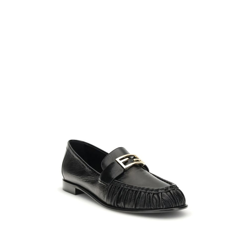 Black Calf Leather Bos Taurus Slip-On LoafersThe nappa Baguette Loafers by Fendi are a perfect example of timeless elegance and Italian craftsmanship. Crafted from soft nappa leather, they’re embellished with the iconic FF metal detail on the vamp, the Ma