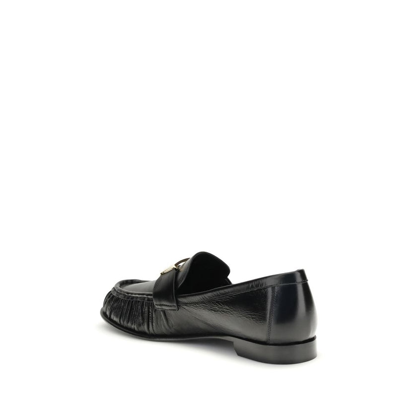 Black Calf Leather Bos Taurus Slip-On LoafersThe nappa Baguette Loafers by Fendi are a perfect example of timeless elegance and Italian craftsmanship. Crafted from soft nappa leather, they’re embellished with the iconic FF metal detail on the vamp, the Ma