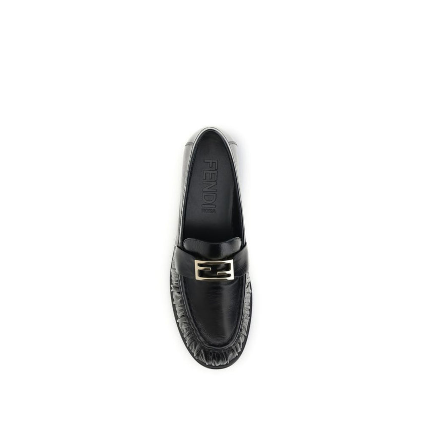 Black Calf Leather Bos Taurus Slip-On LoafersThe nappa Baguette Loafers by Fendi are a perfect example of timeless elegance and Italian craftsmanship. Crafted from soft nappa leather, they’re embellished with the iconic FF metal detail on the vamp, the Ma