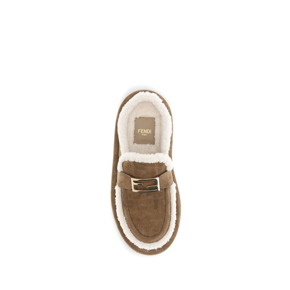 Beige Leather MulesThe Après Chic sheepskin Mules by Fendi combine comfort and style in a sophisticated design. Made of brown suede with a tone-on-tone embossed FF pattern, they feature an inner lining and white sheepskin trim that add softness and warmth
