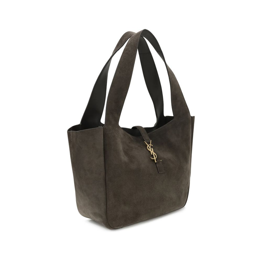 Brown Calf Leather Bos Taurus Shoulder BagThe Le 5 à 7 Bea Tote Bag by Saint Laurent, made of suede leather, is an elegant versatile accessory with a refined design. The closure features a strap with a Cassandre logo plaque and a snap button, giving it a