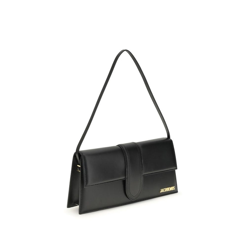 Black Calf Leather Bos Taurus Shoulder BagThe Le Bambino Long Shoulder Bag by Jacquemus is a sophisticated accessory that combines contemporary elegance and functionality. Featuring a flat top handle and an adjustable and removable shoulder strap, it offe