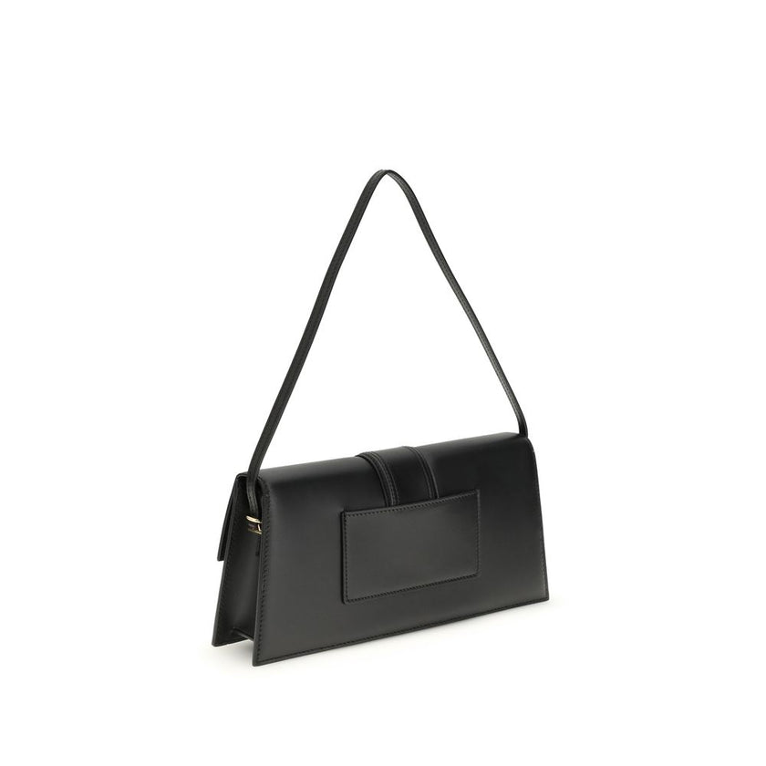 Black Calf Leather Bos Taurus Shoulder BagThe Le Bambino Long Shoulder Bag by Jacquemus is a sophisticated accessory that combines contemporary elegance and functionality. Featuring a flat top handle and an adjustable and removable shoulder strap, it offe