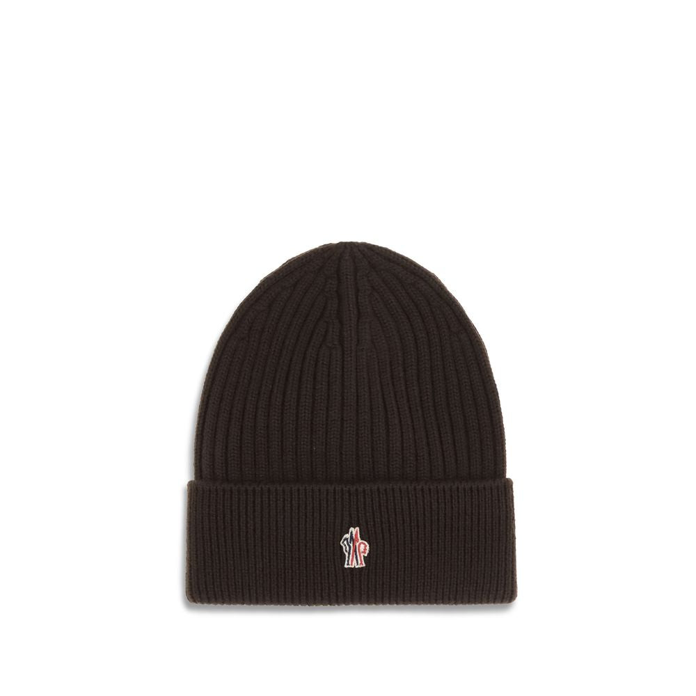 Black Fleece Wool BeanieBeanie Hat by Moncler Grenoble combines functionality and style in an essential cold-weather accessory. Made with ribbed fabrication, it offers a snug and comfortable fit. The Moncler Grenoble logo sewn on the front adds a distinct