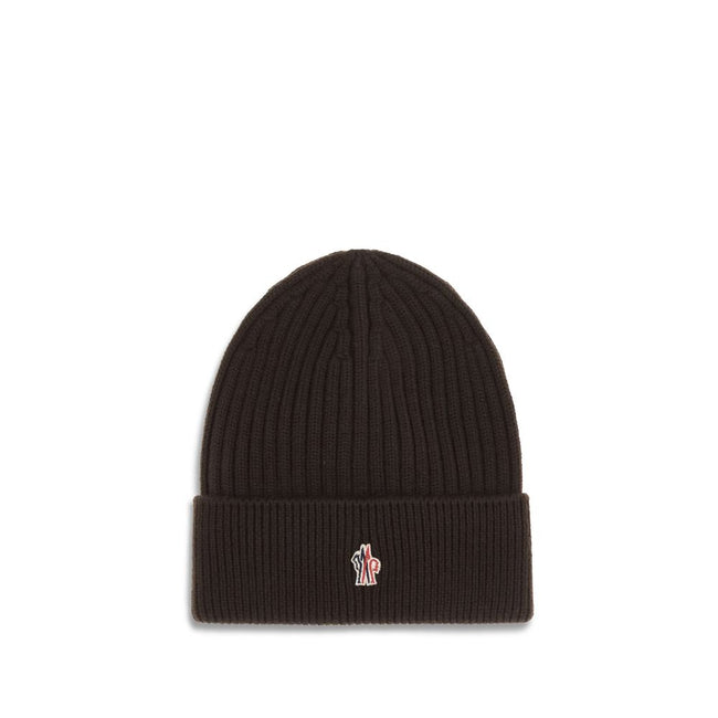 Black Fleece Wool BeanieBeanie Hat by Moncler Grenoble combines functionality and style in an essential cold-weather accessory. Made with ribbed fabrication, it offers a snug and comfortable fit. The Moncler Grenoble logo sewn on the front adds a distinct