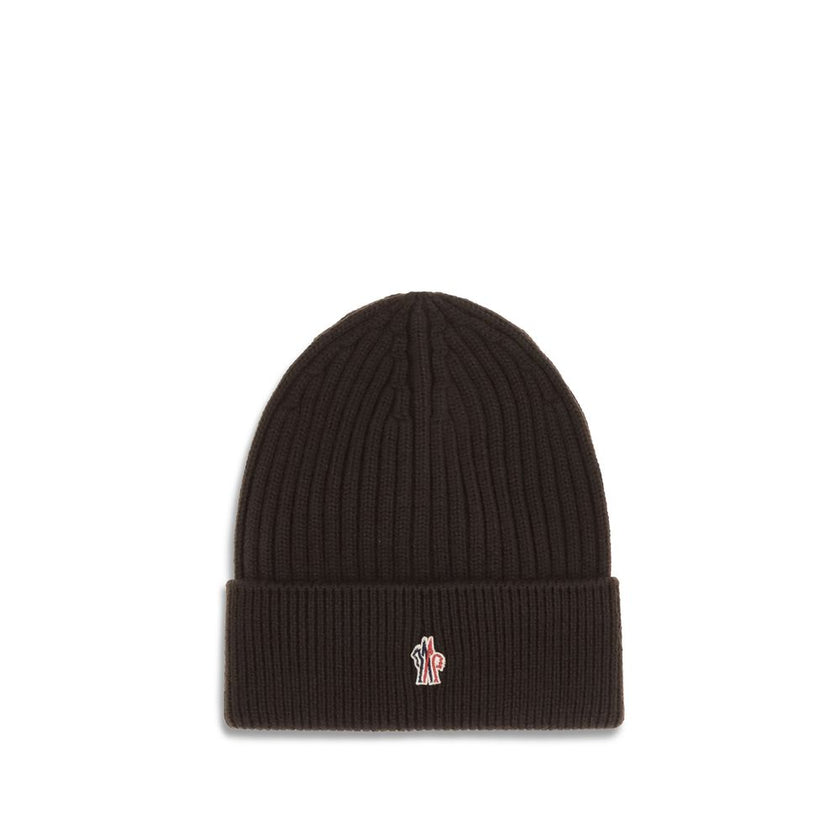 Black Fleece Wool BeanieBeanie Hat by Moncler Grenoble combines functionality and style in an essential cold-weather accessory. Made with ribbed fabrication, it offers a snug and comfortable fit. The Moncler Grenoble logo sewn on the front adds a distinct