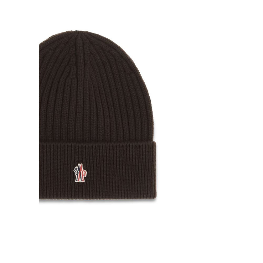Black Fleece Wool BeanieBeanie Hat by Moncler Grenoble combines functionality and style in an essential cold-weather accessory. Made with ribbed fabrication, it offers a snug and comfortable fit. The Moncler Grenoble logo sewn on the front adds a distinct