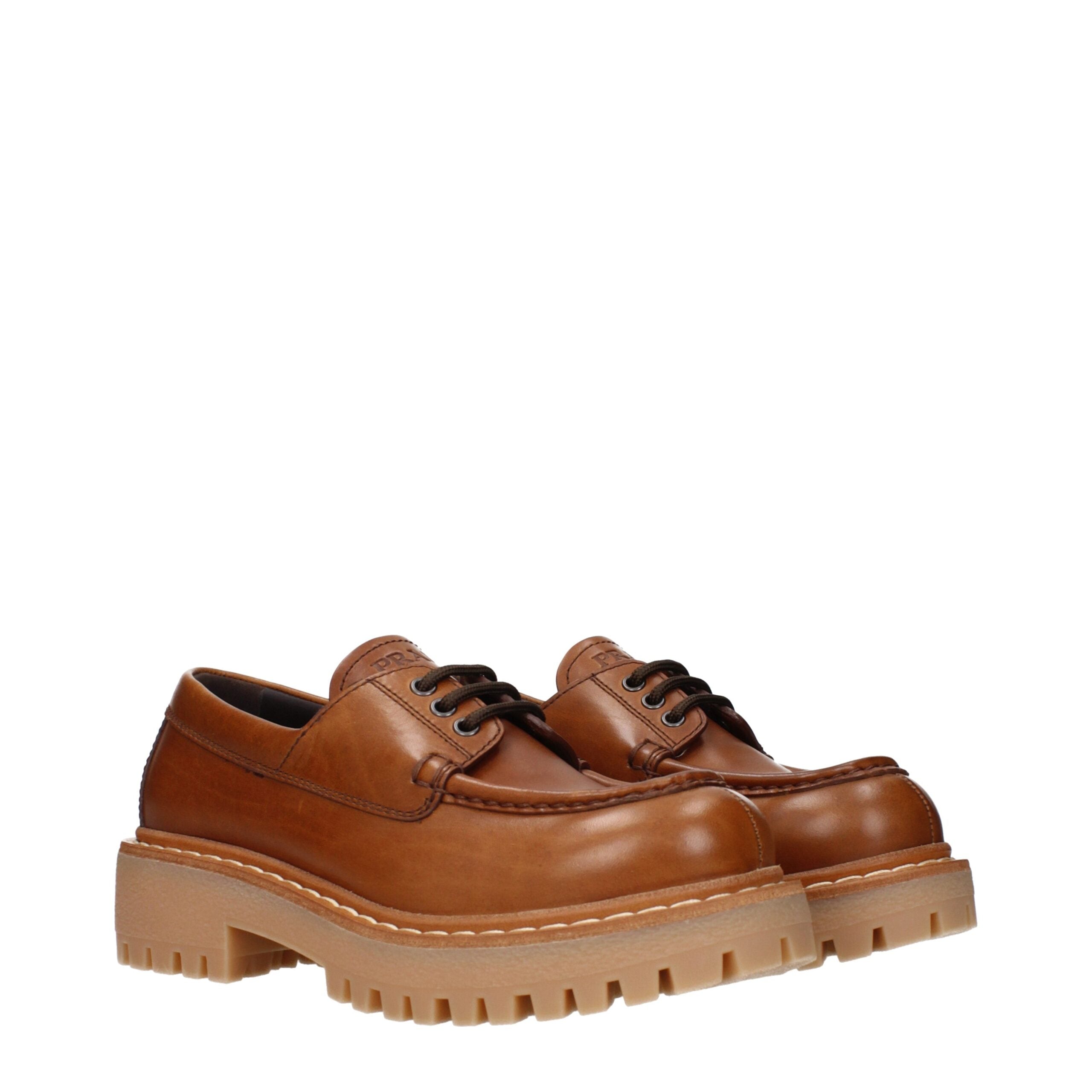 Brown Leather Oxfords And DerbiesDescription: The product with MPN 1E802N070045F0046 and code F84310 leather in brown is a lace up and monkstrap designed by Prada. It has features like front logo, back logo, vintage effect, aged effect.Brown Leather Oxfor