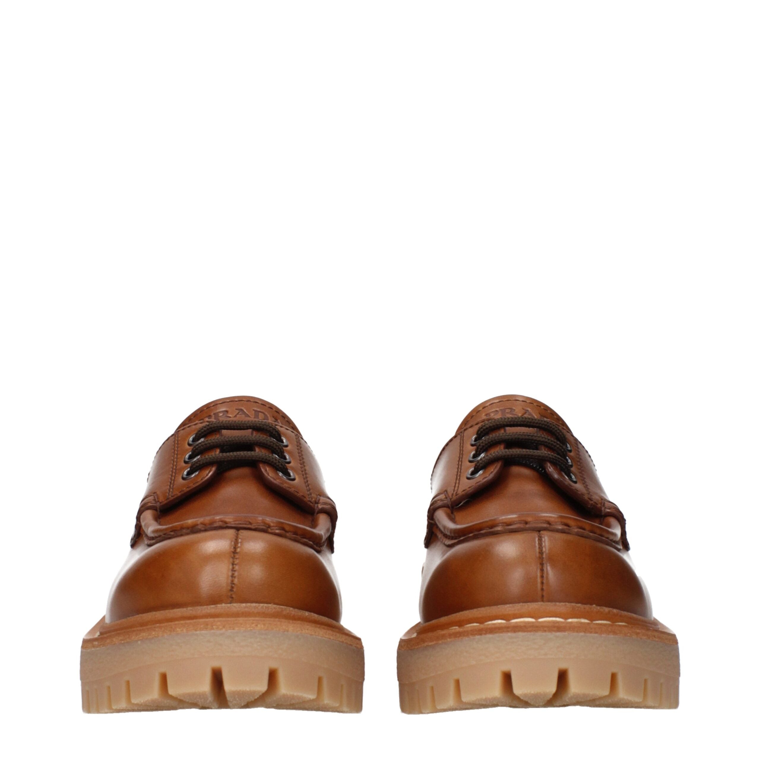 Brown Leather Oxfords And DerbiesDescription: The product with MPN 1E802N070045F0046 and code F84310 leather in brown is a lace up and monkstrap designed by Prada. It has features like front logo, back logo, vintage effect, aged effect.Brown Leather Oxfor