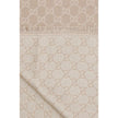 Beige Wool ScarfThe GG Supreme print wool Scarf by Gucci combines warmth and style in an iconic Maison accessory. Crafted from a wool blend with lurex threads, it features a GG print across the entire surface, while frayed hems complete the design with a