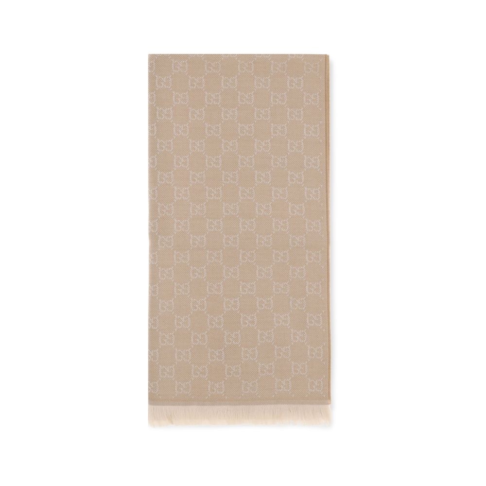 Beige Wool ScarfThe GG Supreme embroidered wool Scarf by Gucci combines warmth and sophistication in a distinctive Maison accessory. Made of pure wool, it features GG embroidery across the entire surface, while frayed ends complete the design with a touch